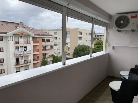Glazed terrace with outdoor seating and a city view. - image 15