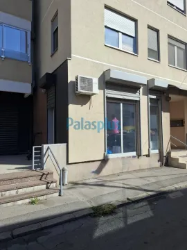 Exterior view of the entrance to the commercial space on the ground floor of a residential building. - image 11