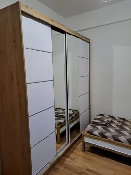 A bedroom with a large wardrobe and a single bed. - image 6