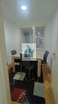 Dining room with a table, chairs, and a window. - image 4