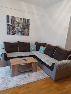 Living room with a corner sofa and a coffee table. - image 2