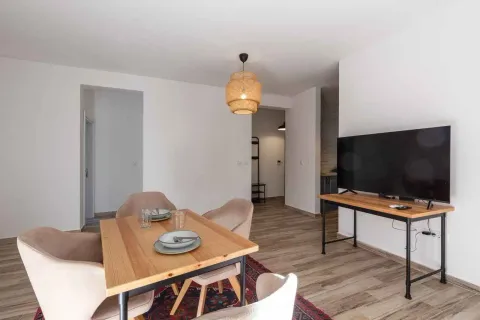 Living room with a dining table and a TV. - image 7