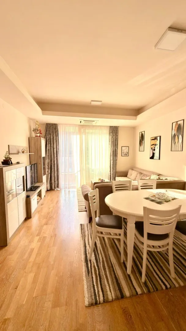 Living room with dining area, sofa set, and access to the terrace.