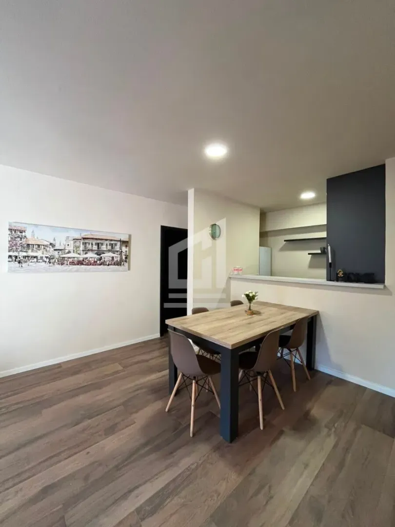 Dining area with a wooden table and modern chairs.
