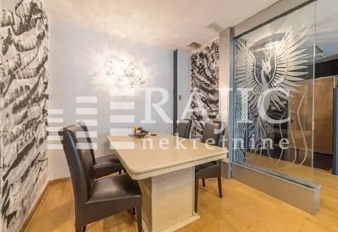 Dining room with a table, chairs, and decorative wall wallpapers.