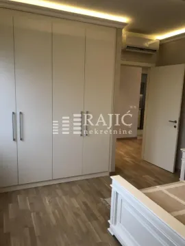 Furnished bedroom with a large built-in wardrobe and a double bed. - image 6