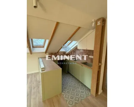 Small attic kitchen with skylights and wooden elements. - image 3