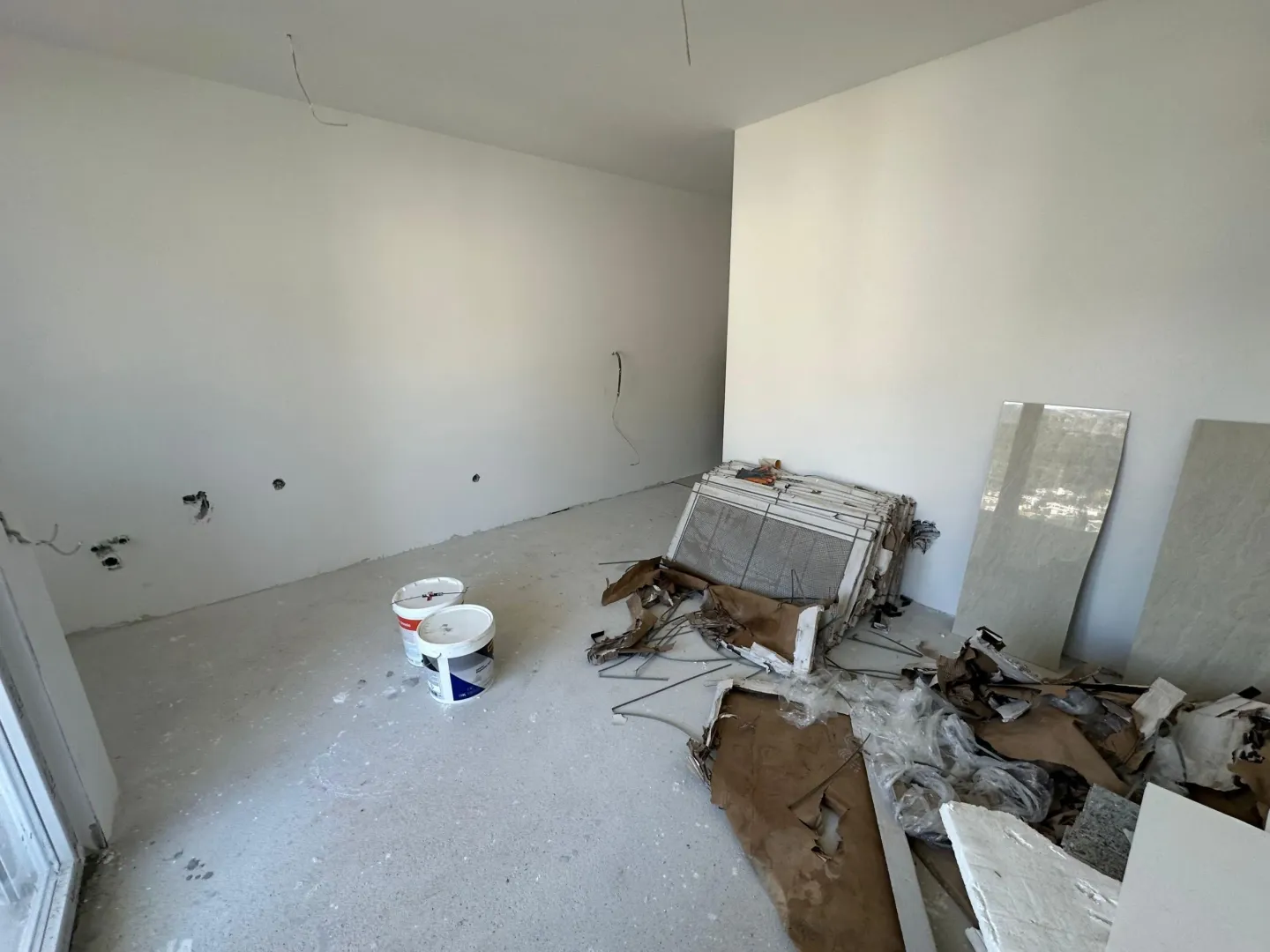 Empty room under construction with building materials.