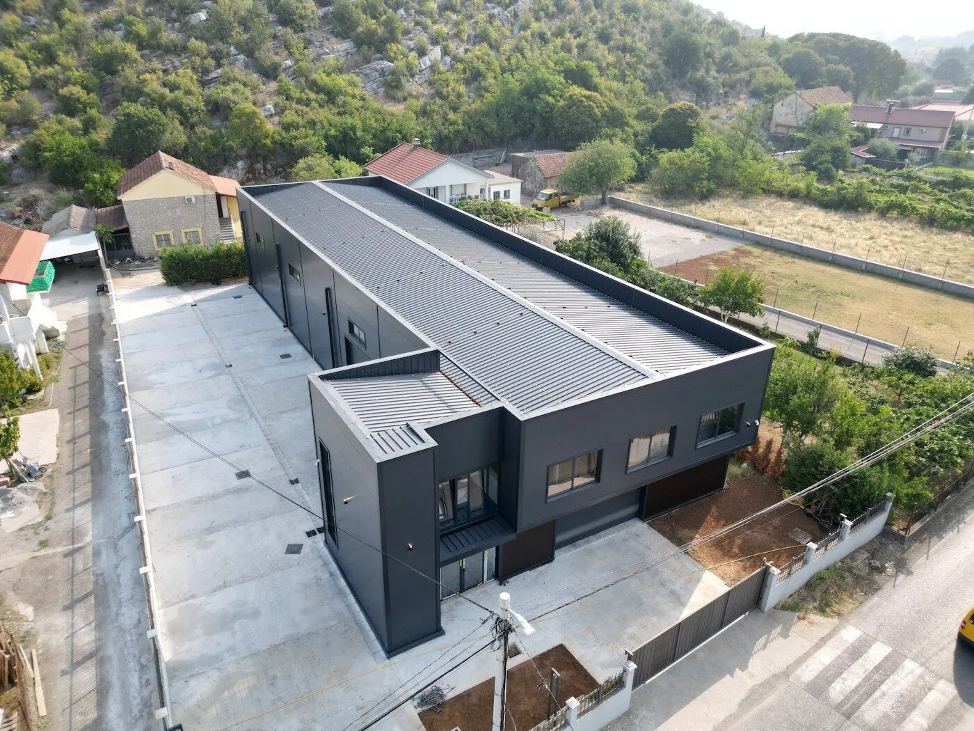 Aerial view of a modern commercial building with parking.