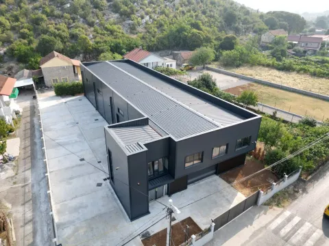 Aerial view of a modern commercial building with parking. - image 2