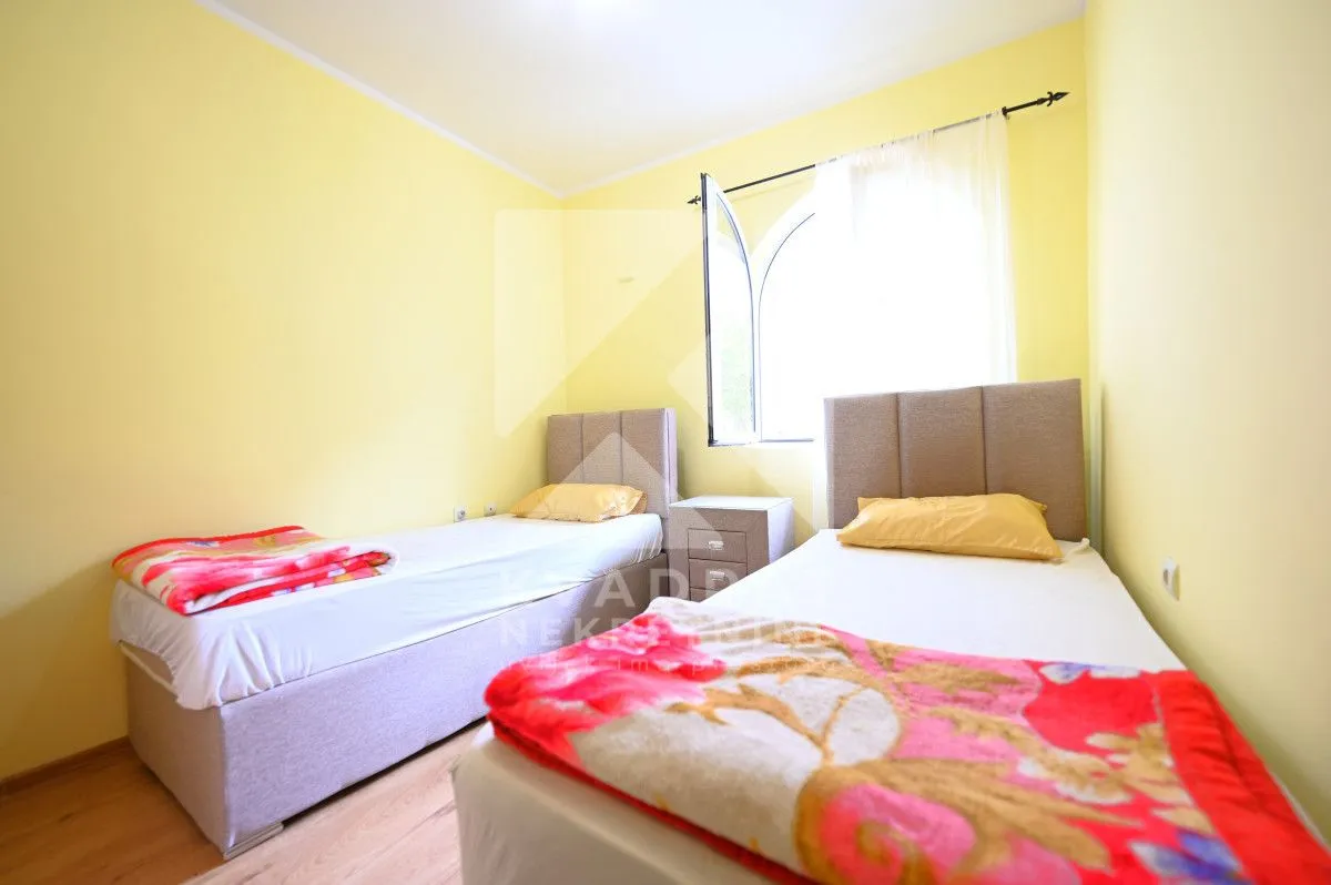Bedroom with two single beds and a window.