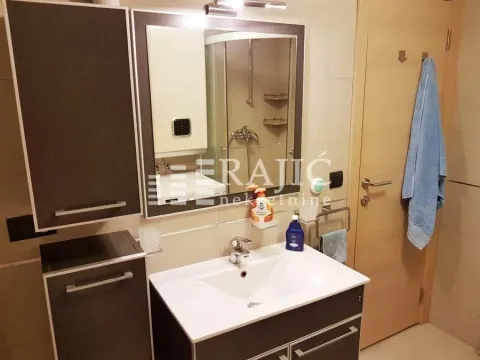 Modernly equipped bathroom with a washbasin, mirror, and shower cabin. - image 11