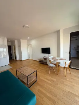 Living room with dining area and wooden flooring. - image 6