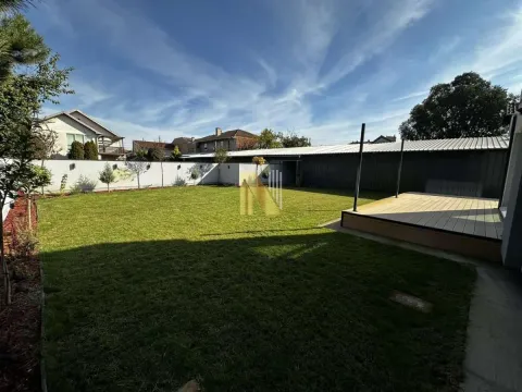 Landscaped yard with lawn and wooden platform. - image 14