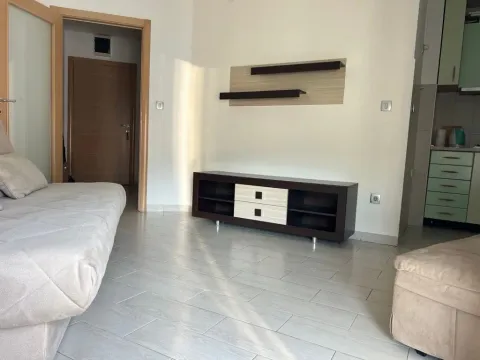 Living room with a sofa and TV cabinet. - image 3