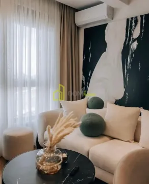 Comfortable living room with a light sofa and decorative art details on the wall. - image 7