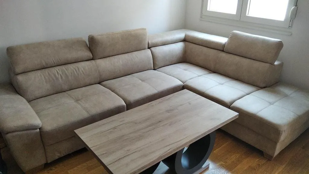 Corner sofa and wooden table in the living room.