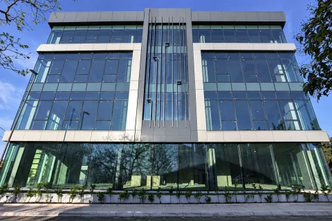 Modern commercial building with a glass facade and metal elements. - image 4