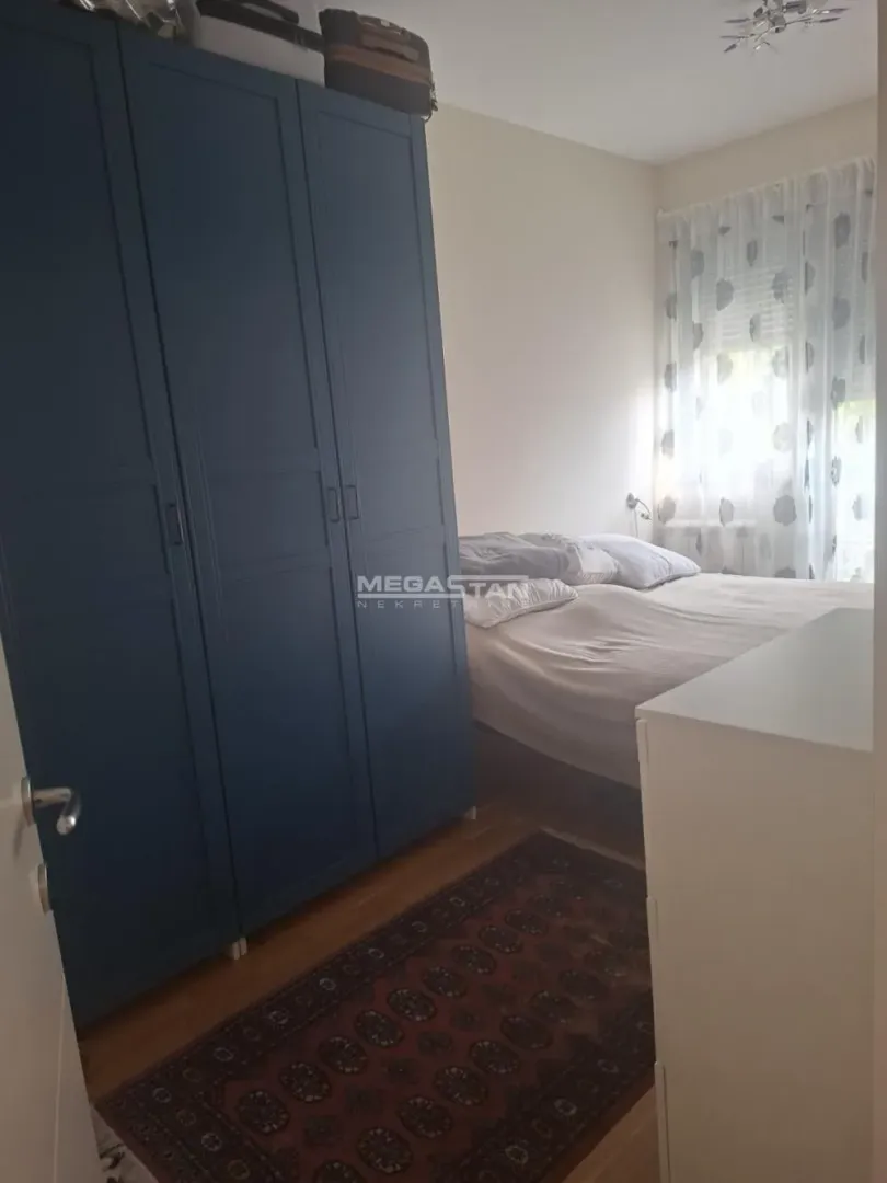 Bedroom with a double bed and a blue wardrobe.