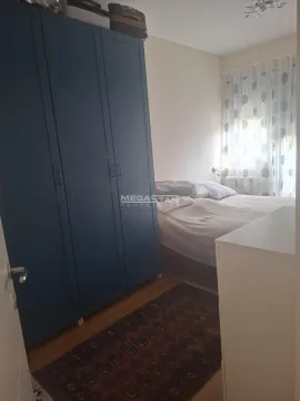 Bedroom with a double bed and a blue wardrobe. - image 4