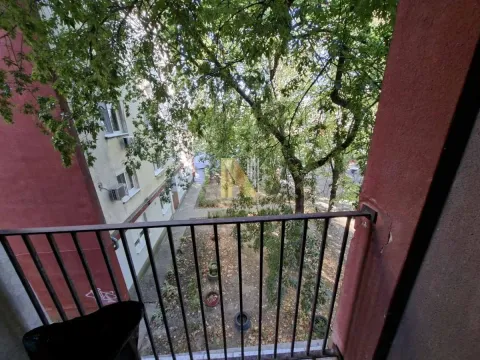 View from the balcony overlooking the courtyard and trees. - image 6