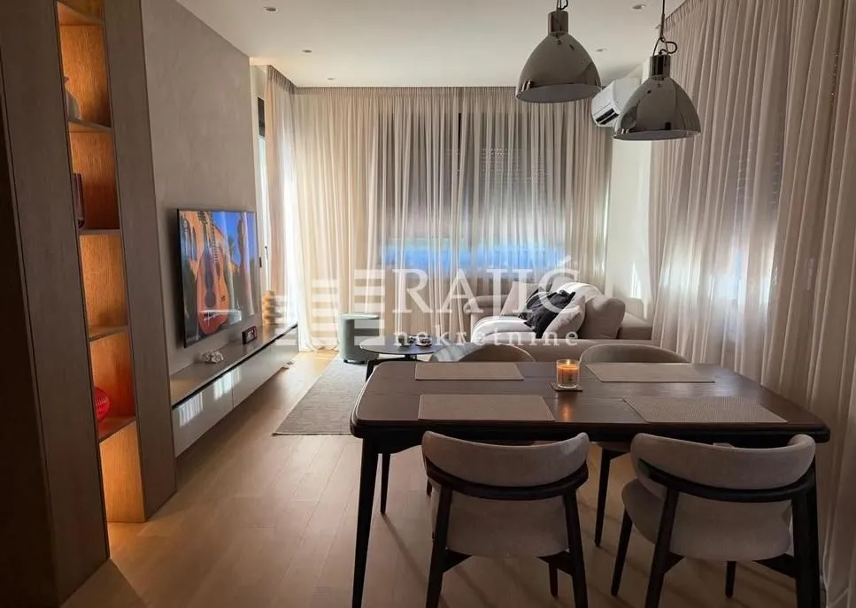 Living room with dining area and modern furniture.