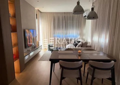 Living room with dining area and modern furniture. - image 2