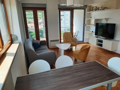 Living room with a sofa set, television, and dining table. - image 8