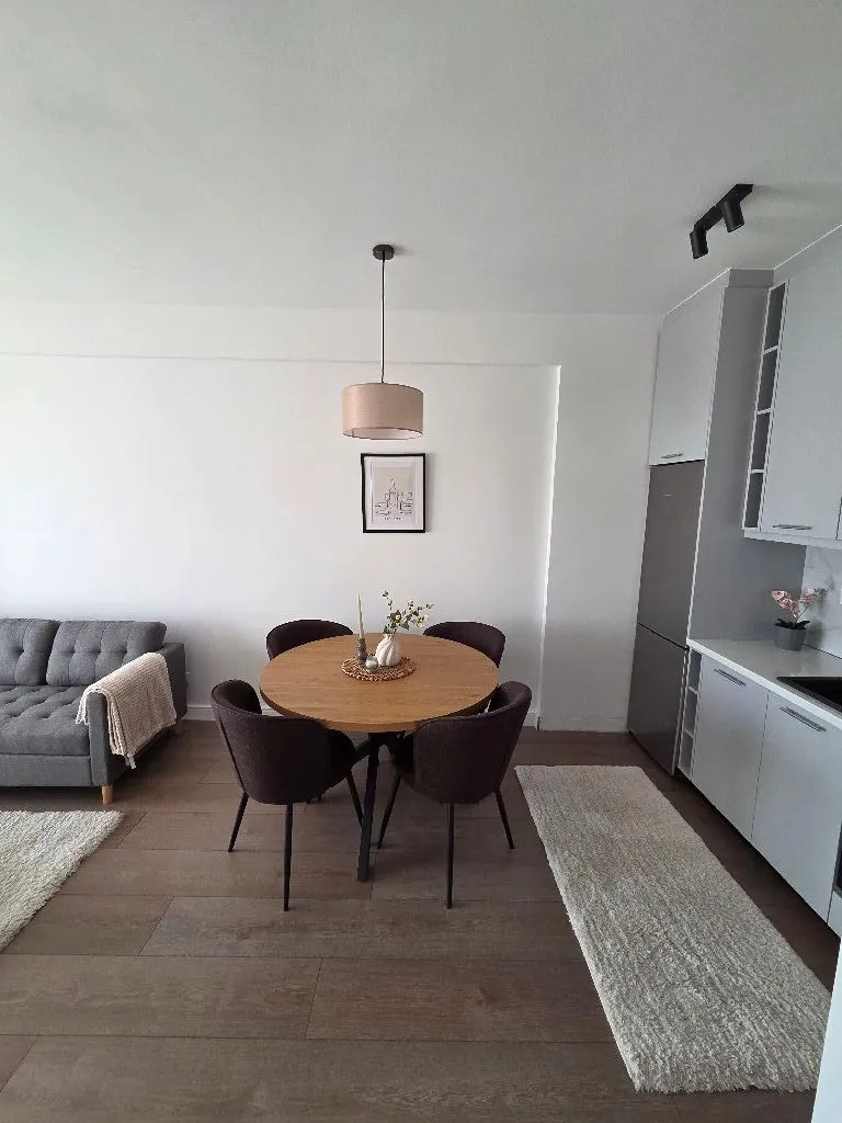 Living room with dining area and modern kitchen.