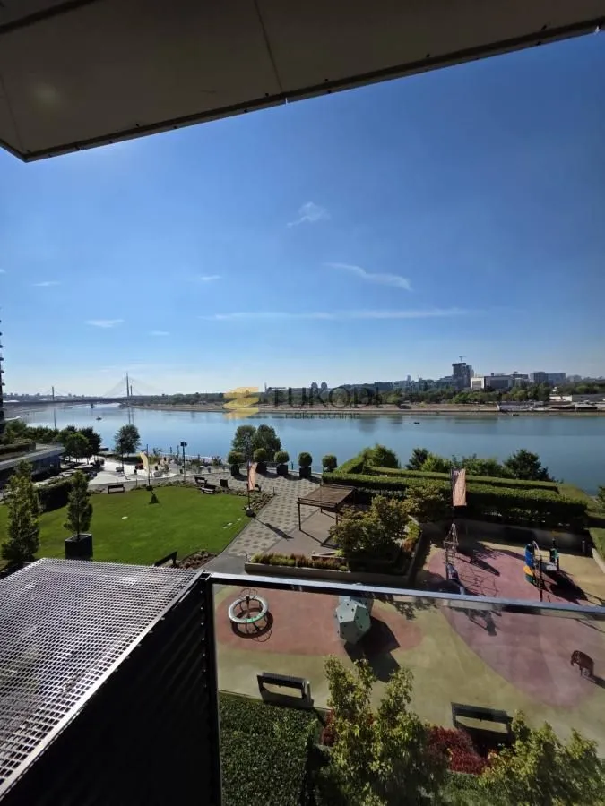 View from the terrace towards the river and landscaped courtyard with a children's playground.