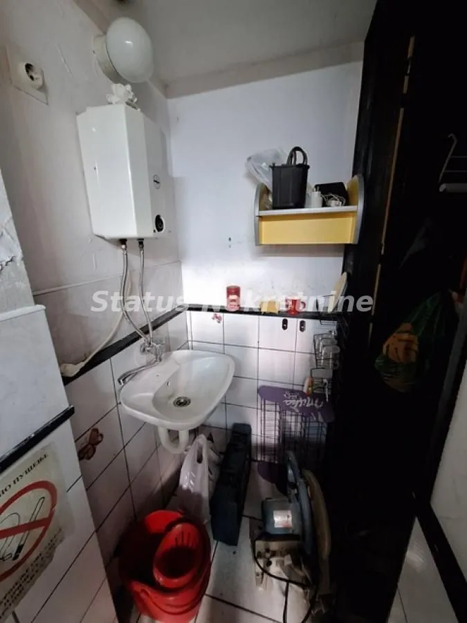Small bathroom with a sink and water heater.