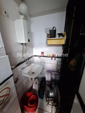 Small bathroom with a sink and water heater. - image 6