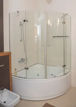 Modern bathroom with a corner shower cabin and hydromassage bathtub. - image 14