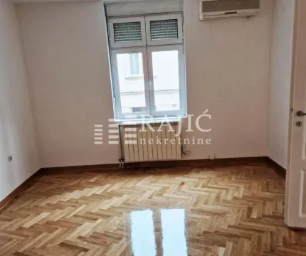 Empty room with parquet flooring and a window. - image 13