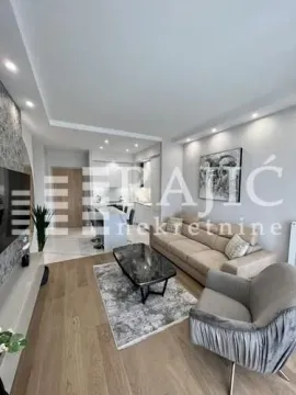 Modern living room with a sofa and a view towards the kitchen. - image 2