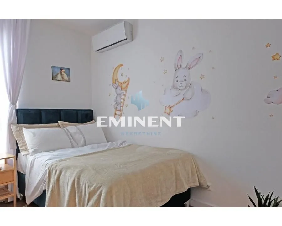 Children's bedroom with a double bed and wall stickers.