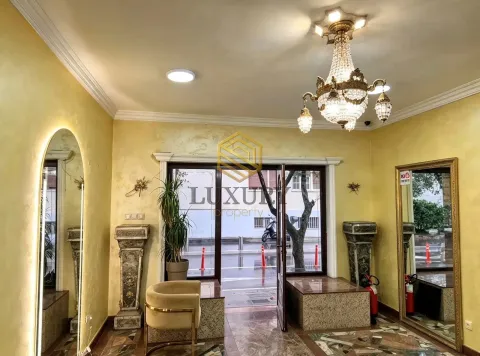 Spacious and luxuriously decorated living room with a crystal chandelier. - image 2