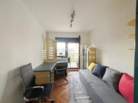 Small room with a desk, sofa, and access to a terrace. - image 11