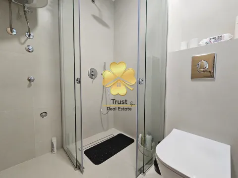 Modern bathroom with a glass shower enclosure and built-in toilet. - image 7