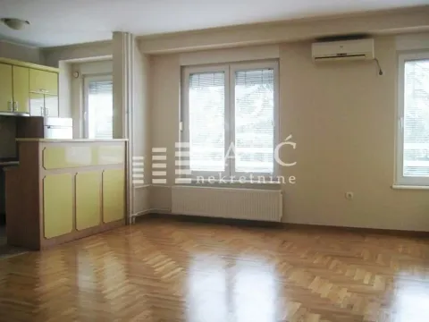 Living room connected to the kitchen, with parquet flooring and large windows. - image 3