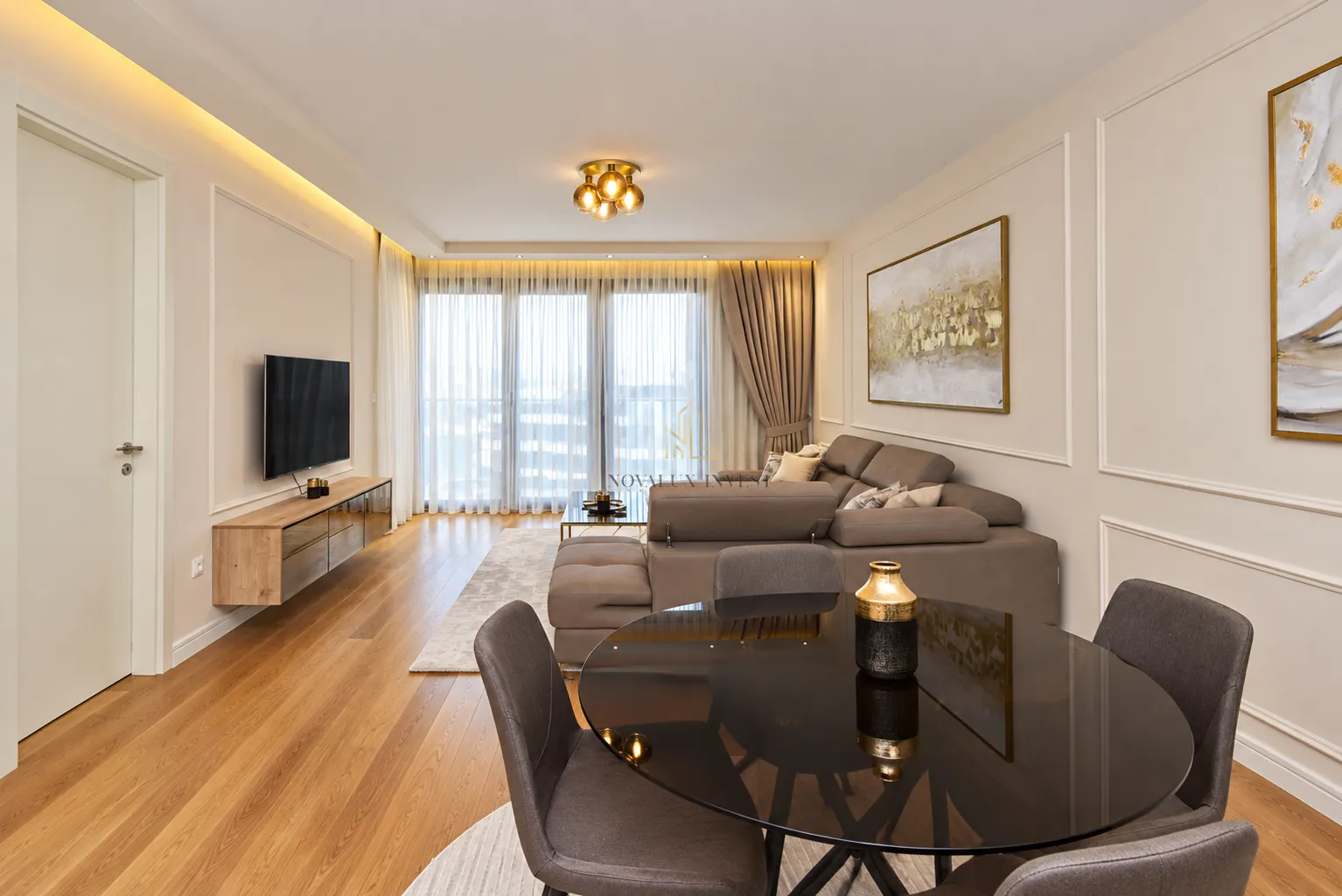 Living room with dining area, sofa and TV.