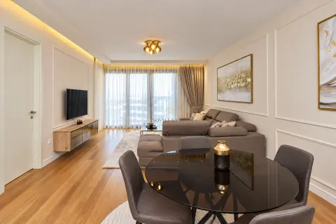 Living room with dining area, sofa and TV. - image 2