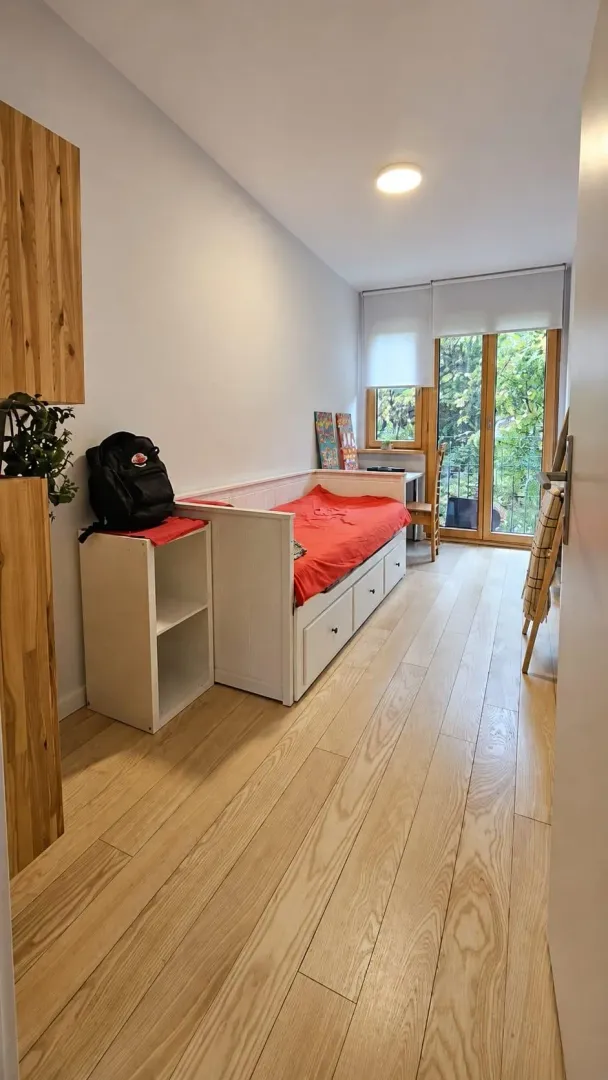 Children's bedroom with a bed, desk, and access to the terrace.