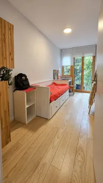 Children's bedroom with a bed, desk, and access to the terrace. - image 13