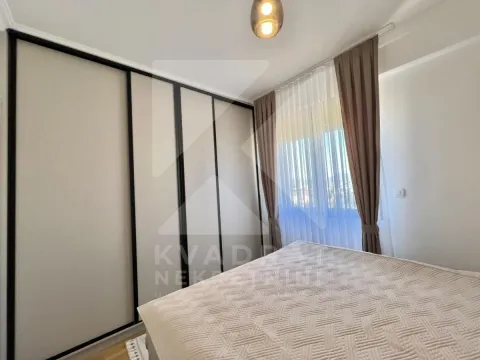 Bedroom with a large built-in wardrobe and a window with curtains. - image 6