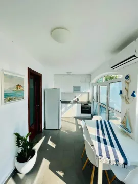 Kitchen with dining area and access to the terrace. - image 2