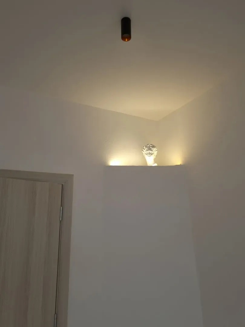 Interior detail featuring a decorative sculpture and lighting.