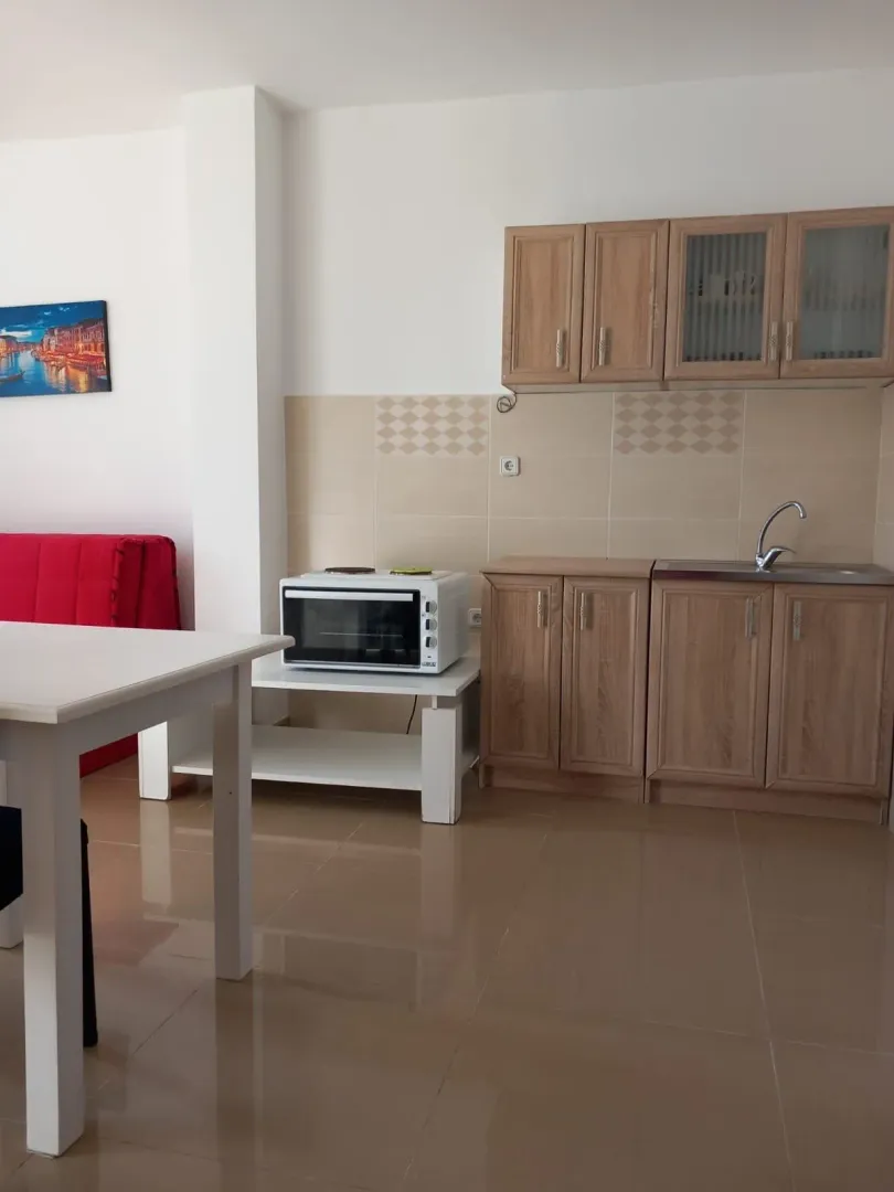 Small kitchen with wooden cabinets and a sink.