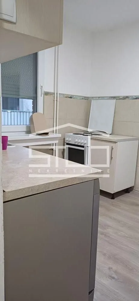 View of a smaller kitchen with a stove and countertops.