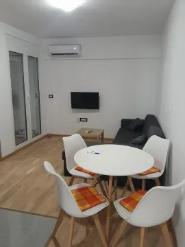 Living room with a dining table and sofa. - image 10